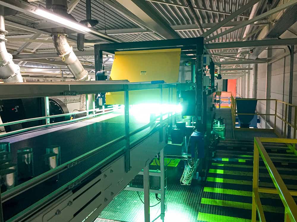 A view of an assembly line device with bright light emitting from it